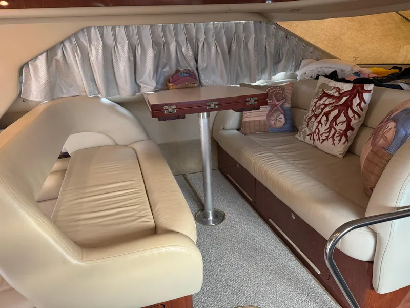 Slide: The Image of Luxurious interior of 2003 Sea Ray 400 Sedan Bridge with plush seating and decorative pillows. - 20