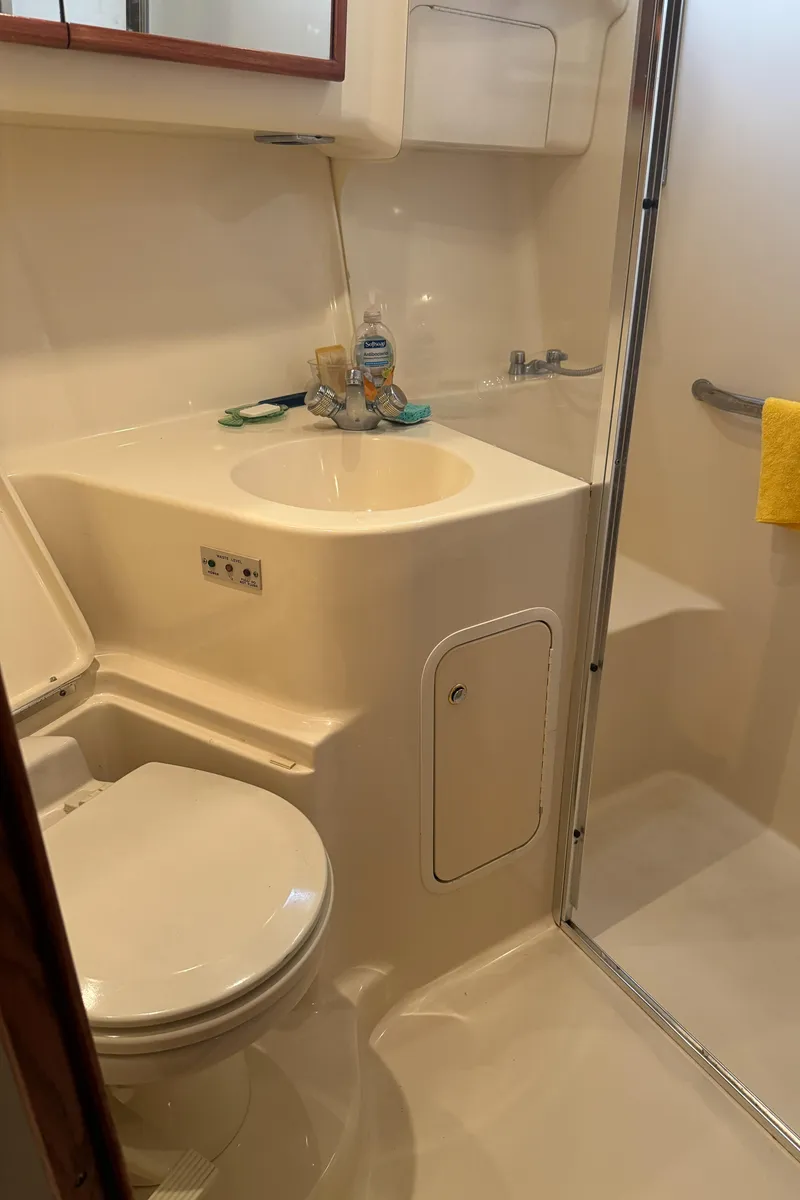 Slide: The Image of Bathroom interior of 2003 Sea Ray 400 Sedan Bridge yacht, featuring sink and shower. - 25