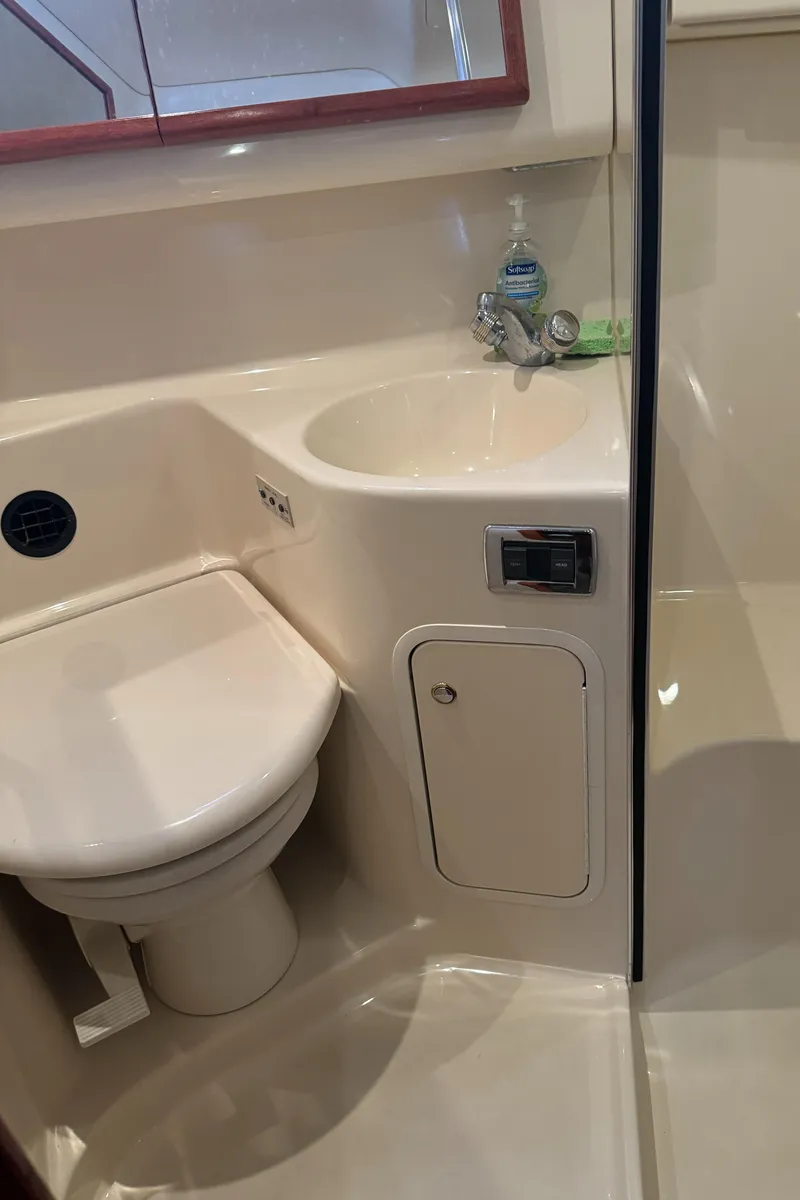 Slide: The Image of 2003 Sea Ray 400 Sedan Bridge bathroom with sink and toilet. - 28