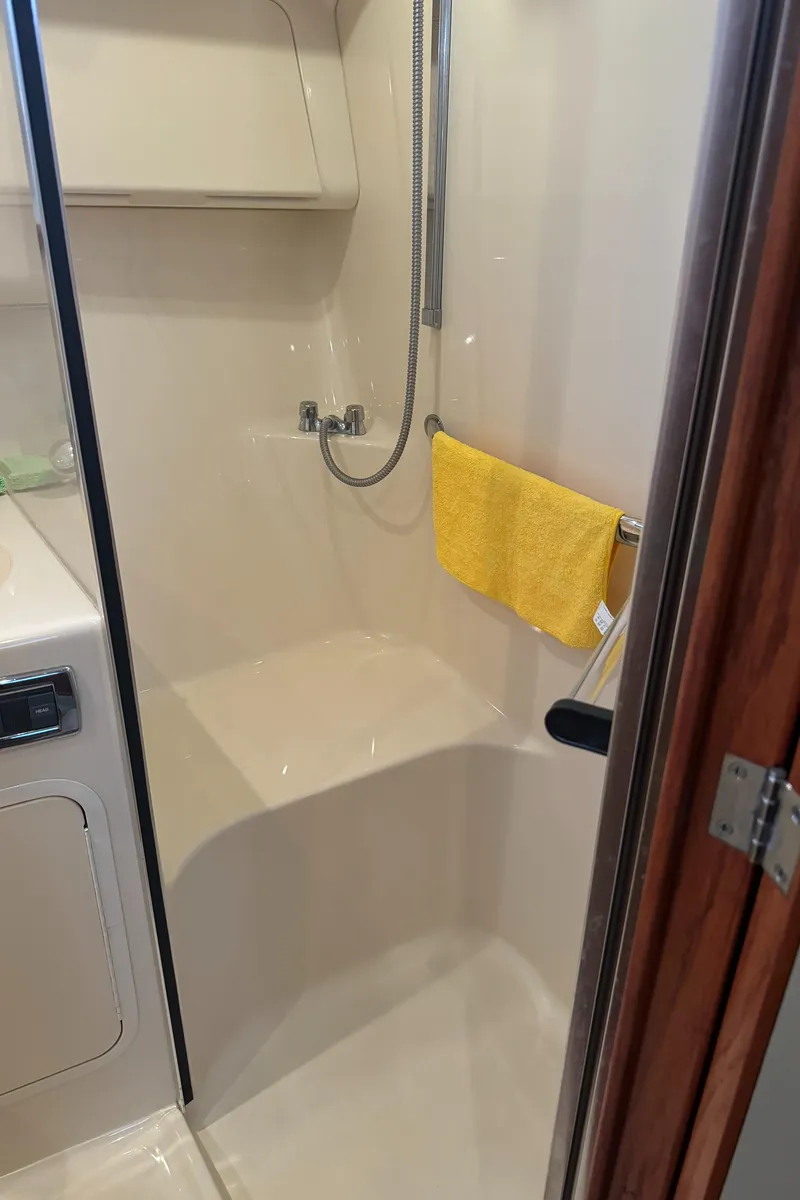 Slide: The Image of Shower area in 2003 Sea Ray 400 Sedan Bridge yacht with yellow towel. - 29