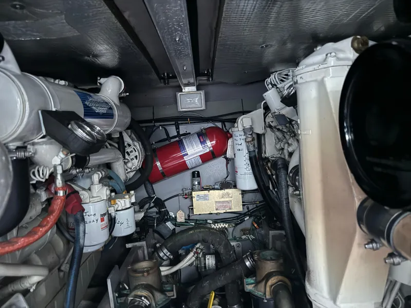 Slide: The Image of Engine room of 2003 Sea Ray 400 Sedan Bridge with fire extinguisher and mechanical components. - 33