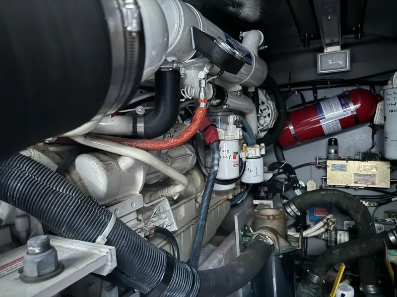 Slide: The Image of Engine compartment of 2003 Sea Ray 400 Sedan Bridge with visible hoses and components. - 34
