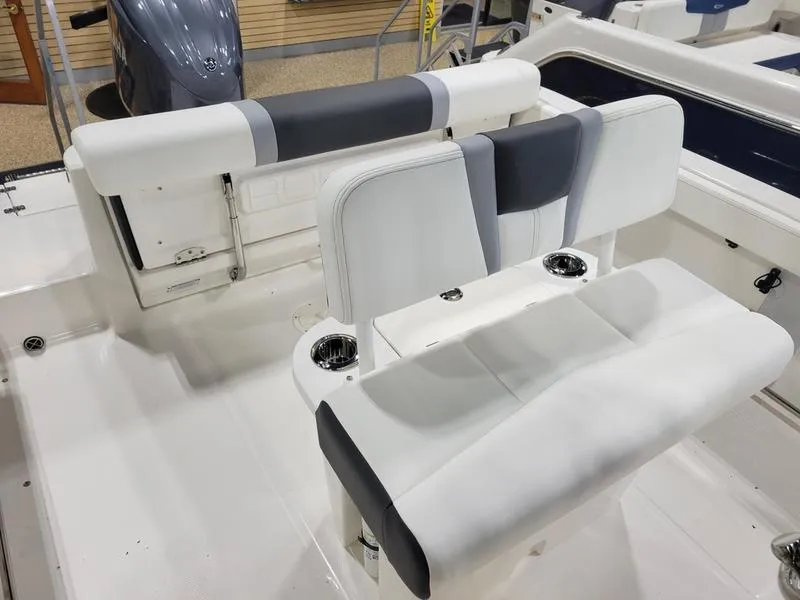 Slide: The Image of 2025 Robalo 222 CC boat interior with white and gray seating. - 10
