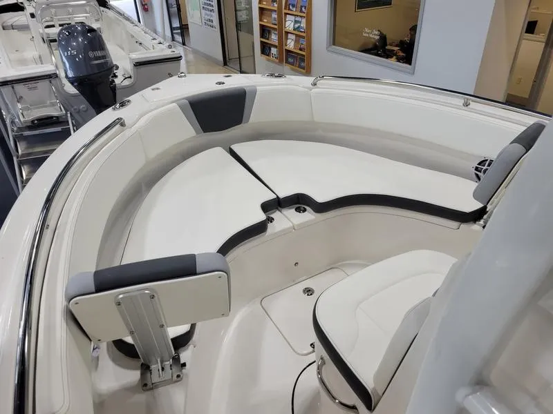 Slide: The Image of 2025 Robalo 222 CC boat interior with cushioned seating and modern design. - 15