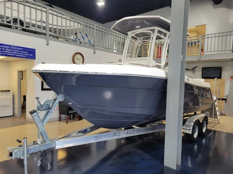Slide: The Image of 2025 Robalo 222 CC boat on trailer in showroom. - 16