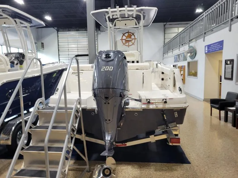 Slide: The Image of 2025 Robalo 222 CC boat with 200 HP engine displayed indoors. - 4