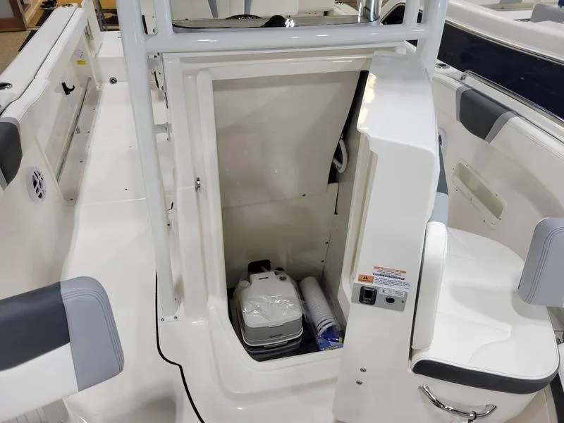 Slide: The Image of 2025 Robalo 222 CC boat interior with storage compartment and seating. - 5