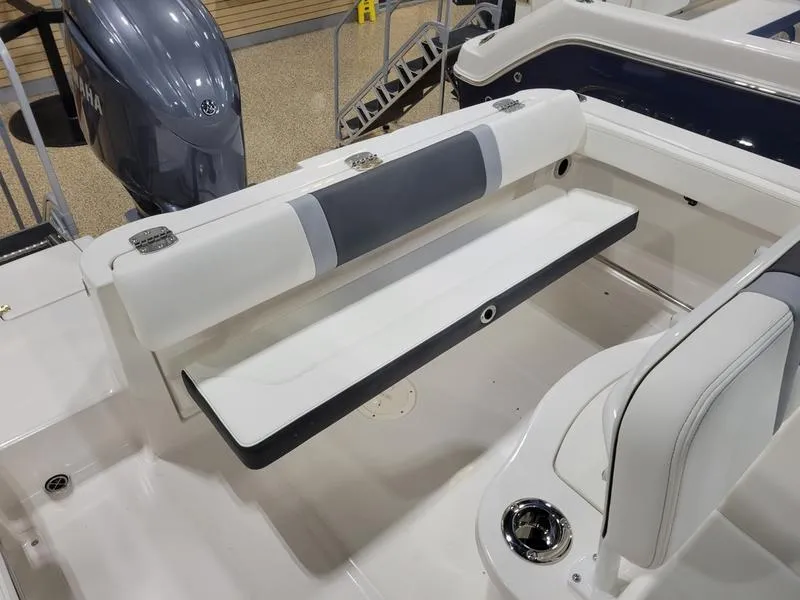 Slide: The Image of 2025 Robalo 222 CC boat interior with foldable seating and engine view. - 8