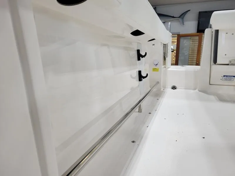 Slide: The Image of 2025 Robalo 222 CC boat interior with rod holders and storage space. - 9