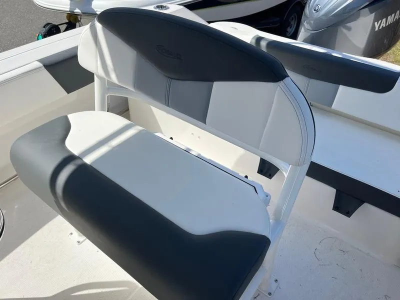 Slide: The Image of 2025 Robalo R 202 EX boat seat with gray and white upholstery. - 2