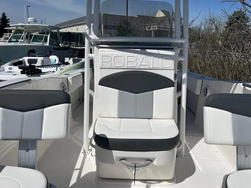 Slide: The Image of 2025 Robalo R 202 EX boat interior with white and gray seating. - 6