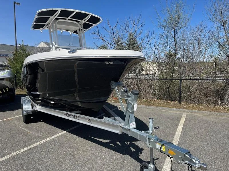 Slide: The Image of 2025 Robalo R 202 EX boat on trailer in parking lot, sunny day. - 8