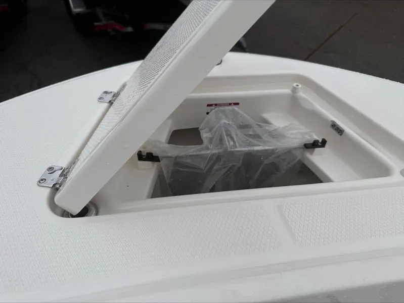 Slide: The Image of 2025 Robalo R 200 boat storage compartment with open hatch. - 17