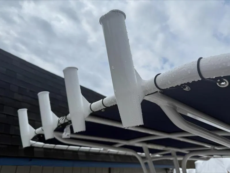 Slide: The Image of Robalo R 200 boat rod holders, 2025 model, with a sleek design against a cloudy sky. - 18