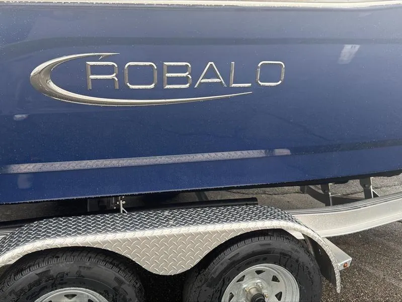Slide: The Image of 2025 Robalo R 200 boat on trailer, blue exterior with logo. - 7
