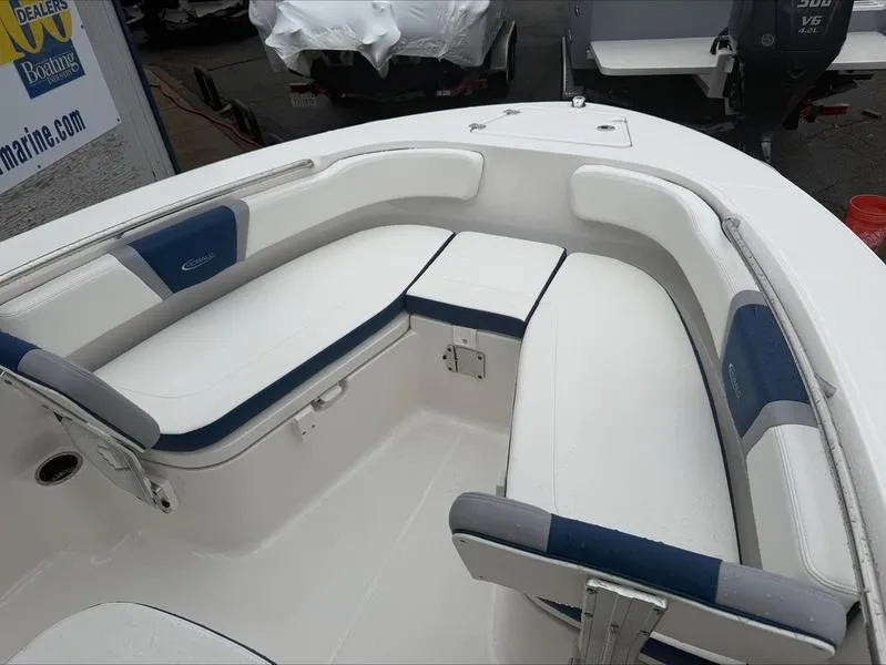 Slide: The Image of 2025 Robalo R 200 boat interior with white and blue cushioned seating. - 8