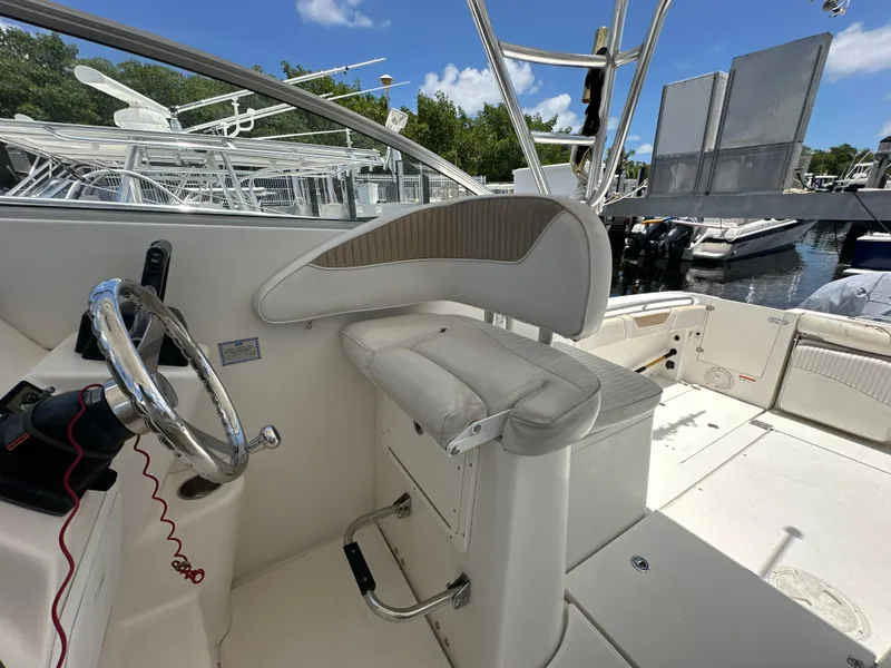 Slide: The Image of 2006 Seaswirl Striper 2901 Walkaround O/B helm station with steering wheel and captain's chair. - 12