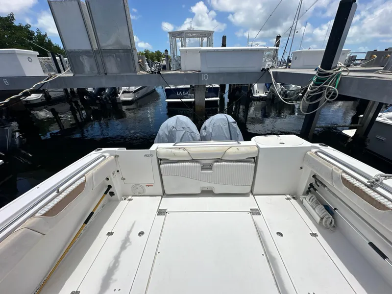 Slide: The Image of 2006 Seaswirl Striper 2901 Walkaround O/B at a marina, rear deck view. - 2
