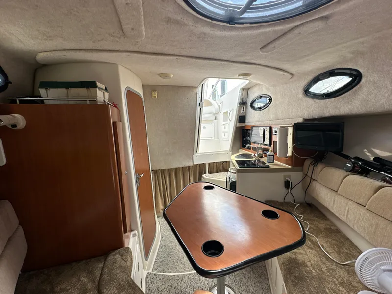 Slide: The Image of 2006 Seaswirl Striper 2901 Walkaround O/B cabin interior with table, seating, and kitchenette. - 20