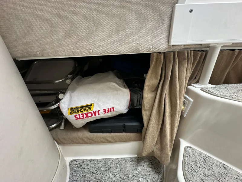 Slide: The Image of Storage compartment in 2006 Seaswirl Striper 2901 Walkaround O/B with life jackets and equipment. - 21