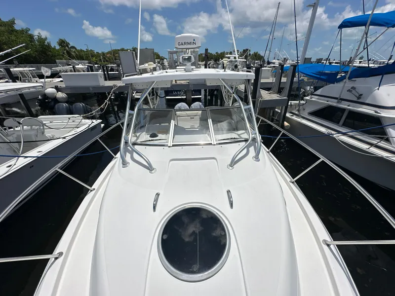 Slide: The Image of 2006 Seaswirl Striper 2901 Walkaround O/B docked at marina, front view. - 25