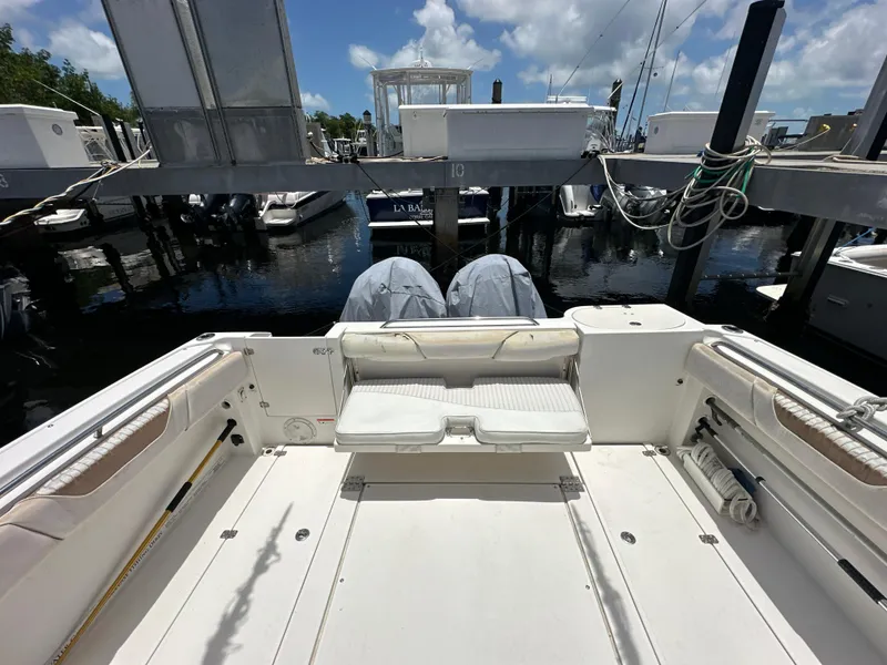 Slide: The Image of 2006 Seaswirl Striper 2901 Walkaround O/B boat docked at marina, rear view. - 3