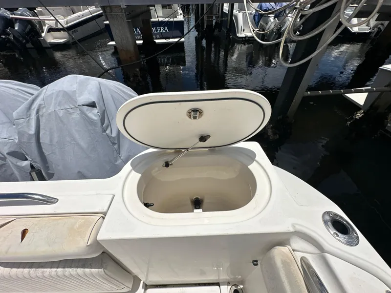 Slide: The Image of 2006 Seaswirl Striper 2901 Walkaround O/B boat with open storage compartment at dock. - 4
