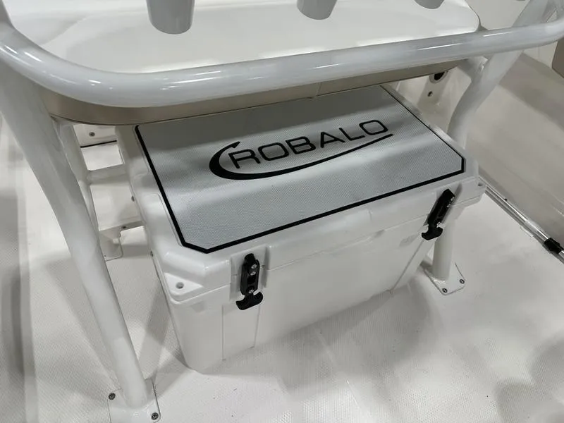 Slide: The Image of Robalo R 180 boat cooler storage area, 2025 model, with secure latches. - 10