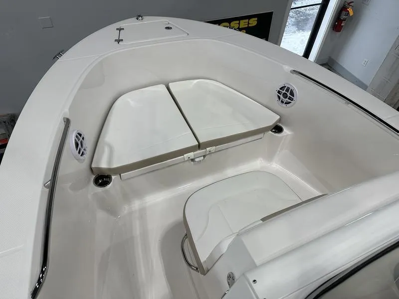 Slide: The Image of 2025 Robalo R 180 boat interior with cushioned seating and storage. - 13