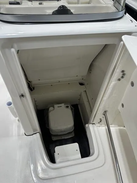 Slide: The Image of 2025 Robalo R 180 boat interior with compact marine toilet. - 14