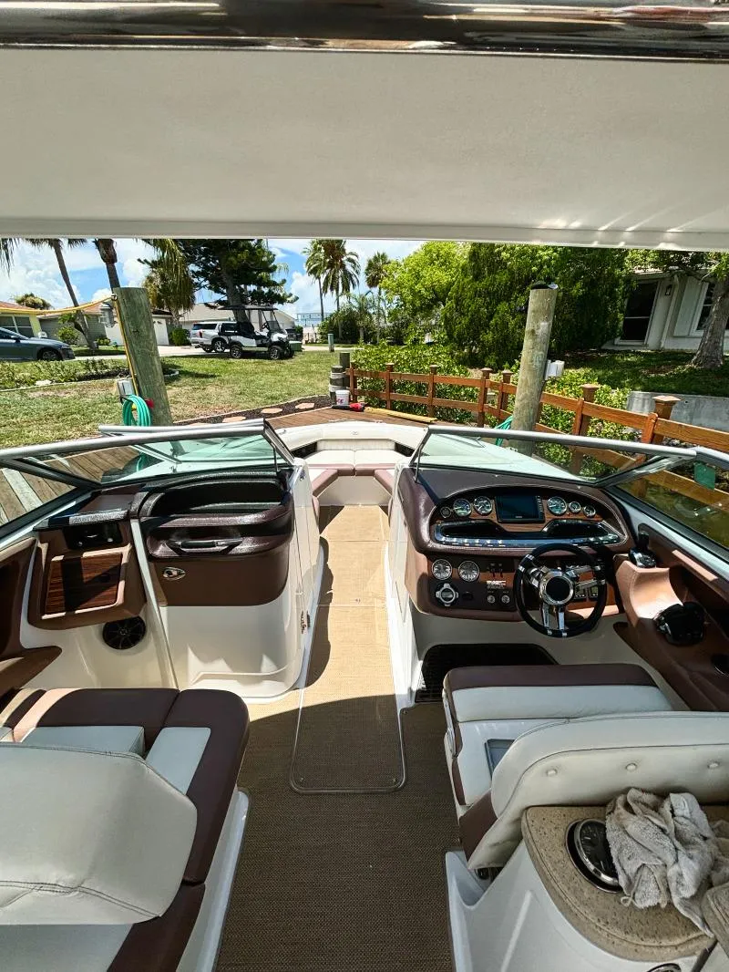 Slide: The Image of Interior of a 2014 Cobalt 302 boat with luxurious seating and modern dashboard. - 10