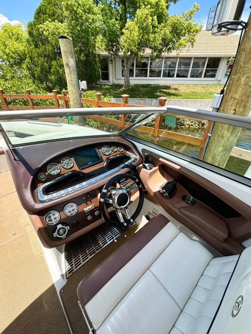 Slide: The Image of 2014 Cobalt 302 boat cockpit with modern dashboard and steering wheel. - 12