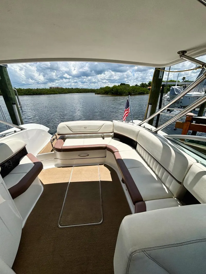 Slide: The Image of 2014 Cobalt 302 boat interior with spacious seating and scenic water view. - 13