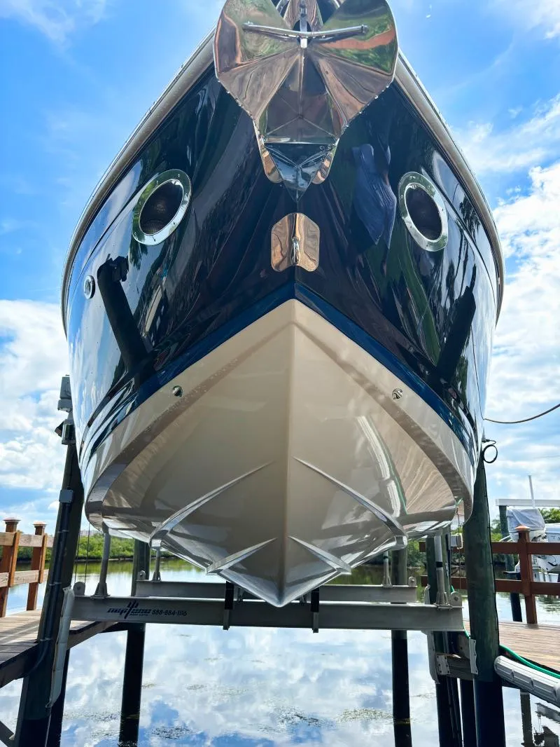 Slide: The Image of 2014 Cobalt 302 boat on a lift, viewed from the front. - 8
