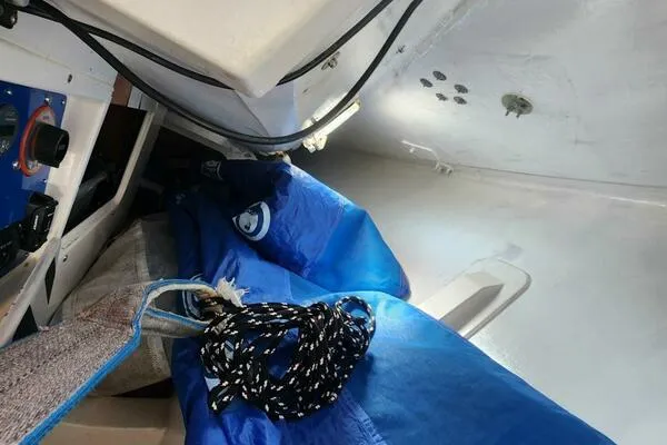 Slide: The Image of Interior of a 1996 Carroll Marine Farr 30 sailboat with blue sail and ropes. - 12