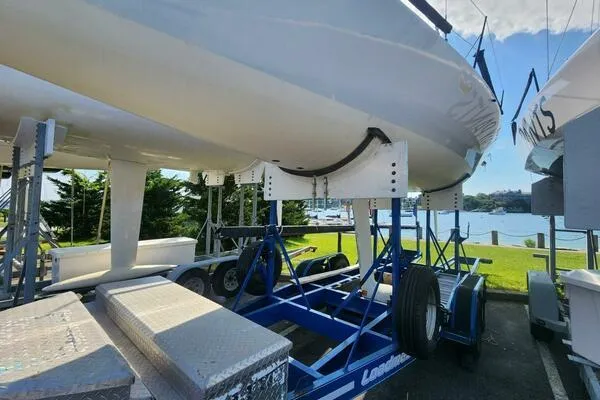Slide: The Image of 1996 Carroll Marine Farr 30 sailboat on a trailer by the waterfront. - 13