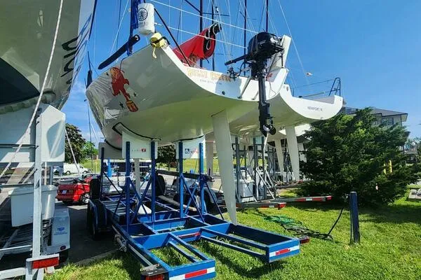 Slide: The Image of Carroll Marine Farr 30 sailboats on trailers, 1996 models, parked on grass under clear sky. - 14