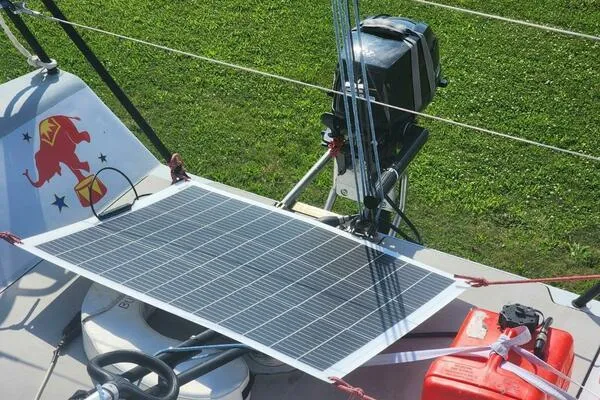 Slide: The Image of Solar panel on 1996 Carroll Marine Farr 30 sailboat with outboard motor and red fuel tank. - 5