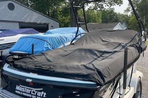 Slide: The Image of 1993 MasterCraft Prostar 205 boat covered and parked in a driveway. - 11