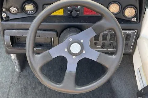 Slide: The Image of 1993 MasterCraft Prostar 205 boat dashboard with steering wheel and control panel. - 5