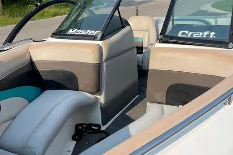 Slide: The Image of 1993 MasterCraft Prostar 205 boat interior with beige and black seats. - 7