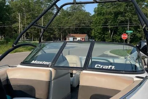 Slide: The Image of 1993 MasterCraft Prostar 205 boat with open seating and windshield. - 8