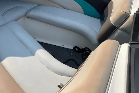 Slide: The Image of 1993 MasterCraft Prostar 205 boat interior with white and teal seating. - 9