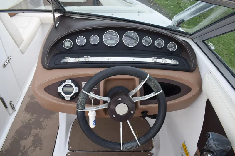 Slide: The Image of 2013 Cobalt 210 WSS boat dashboard with steering wheel and instrument panel. - 4