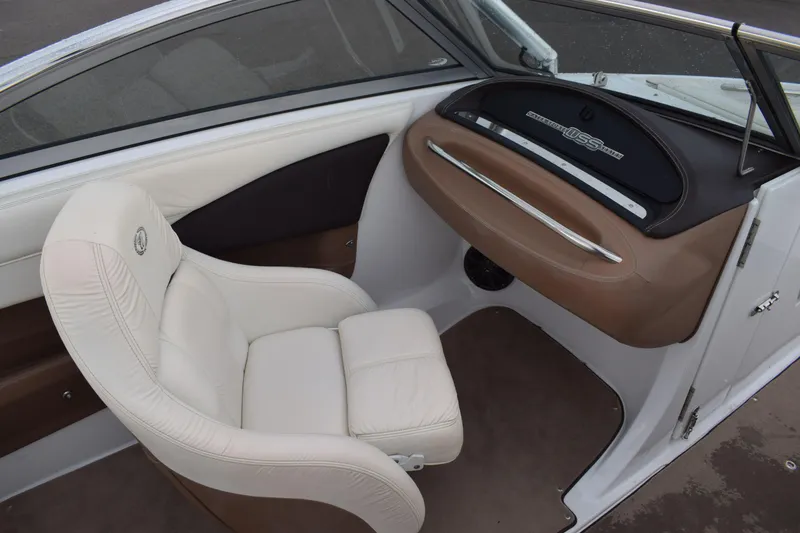 Slide: The Image of 2013 Cobalt 210 WSS boat interior with white leather seat and dashboard. - 5