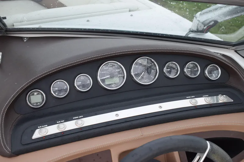Slide: The Image of Dashboard of a 2013 Cobalt 210 WSS boat with gauges and controls. - 6