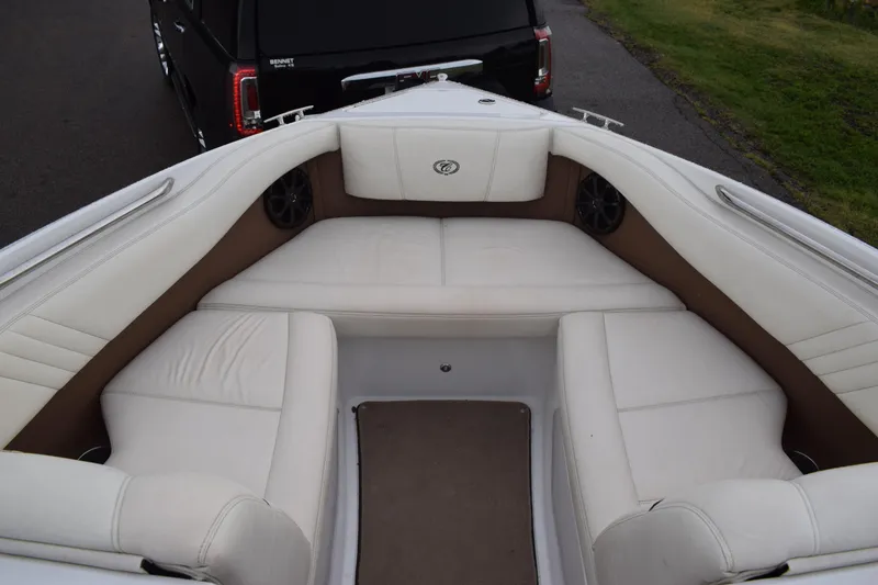 Slide: The Image of 2013 Cobalt 210 WSS boat with white cushioned seating and brown accents. - 7