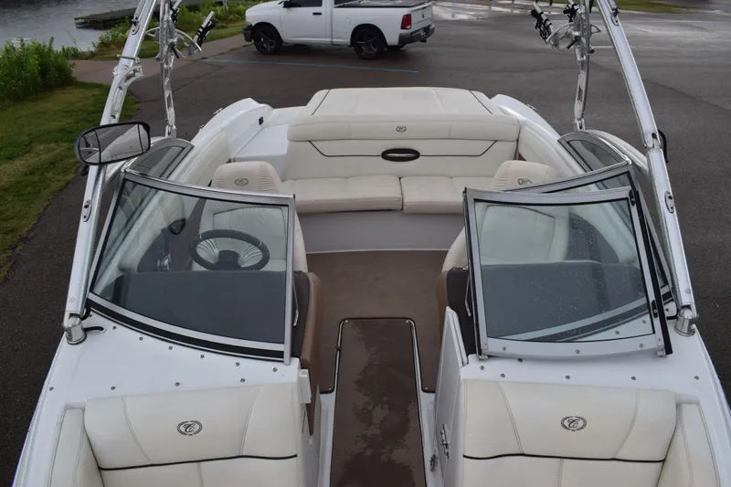Slide: The Image of 2013 Cobalt 210 WSS boat interior with white leather seats and open windshield. - 9