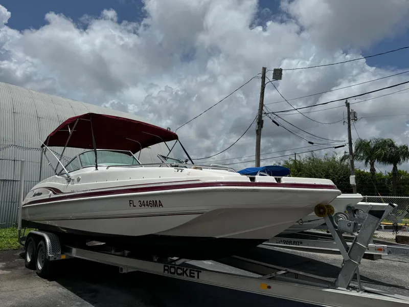 The Image of 1999 Hurricane 232 Fun Deck boat on a trailer with a red canopy. - 1
