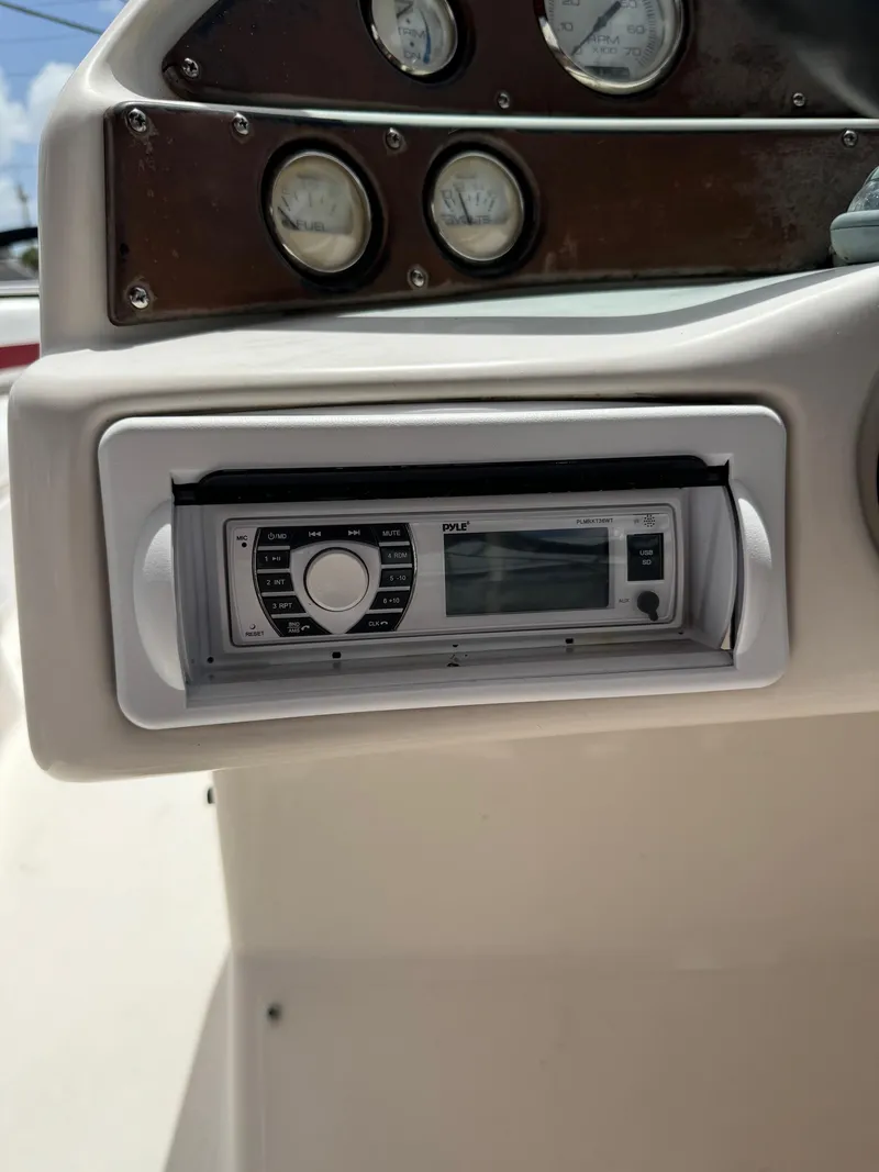 Slide: The Image of 1999 Hurricane 232 FUN DECK boat dashboard with stereo system and gauges. - 15